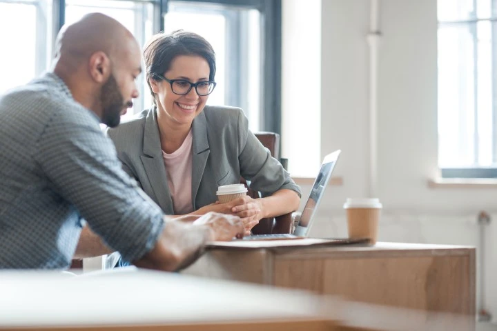 man and woman looking at laptop